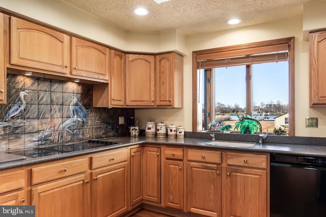 kitchen featuring backsplash, sink, black appliances, and a textured ceiling