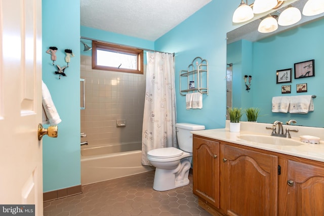 full bathroom featuring tile patterned floors, a textured ceiling, toilet, vanity, and shower / tub combo