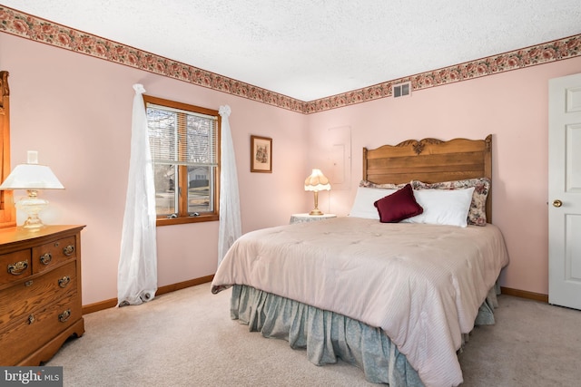 carpeted bedroom featuring a textured ceiling