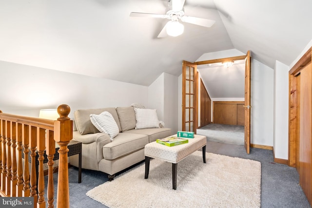 living room featuring ceiling fan, vaulted ceiling, and dark colored carpet