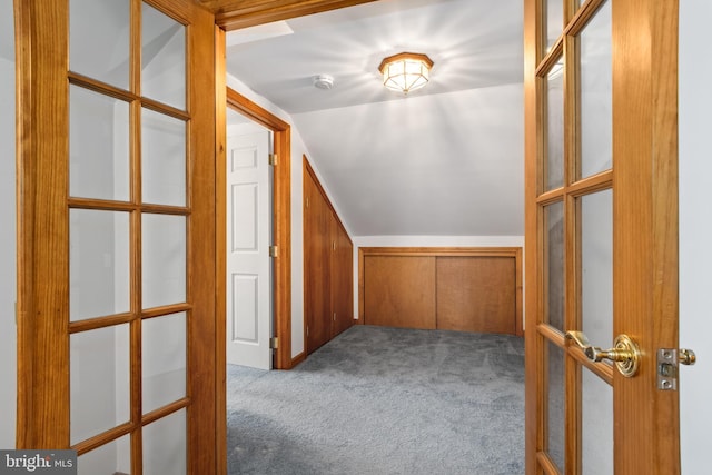 bonus room featuring carpet flooring, french doors, and vaulted ceiling