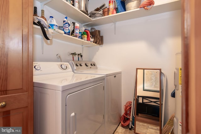 washroom with electric water heater and separate washer and dryer