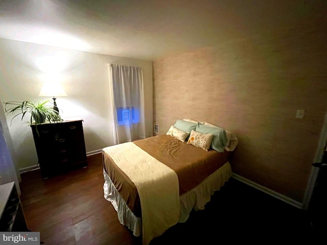 bedroom with dark hardwood / wood-style floors