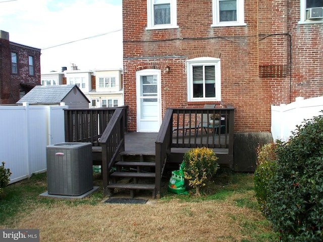 back of property with a wooden deck and central air condition unit