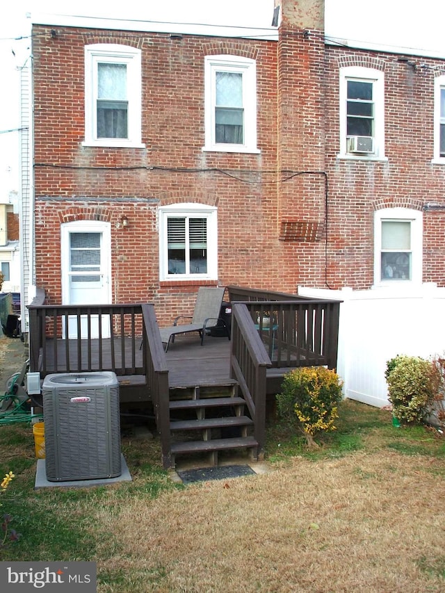 rear view of house with cooling unit and a deck