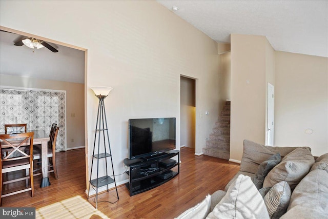 living room with hardwood / wood-style flooring, high vaulted ceiling, and ceiling fan