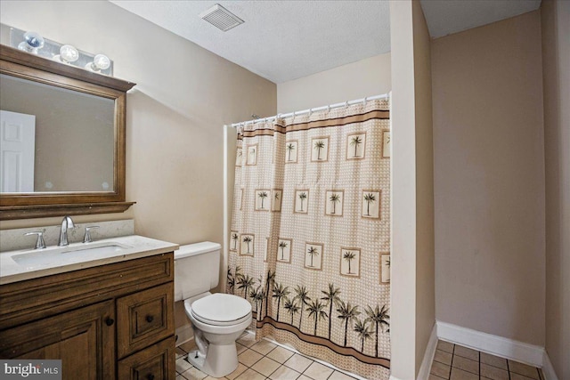 bathroom featuring tile patterned flooring, vanity, a textured ceiling, and toilet