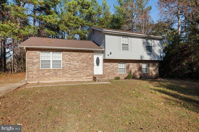 split level home featuring a front lawn