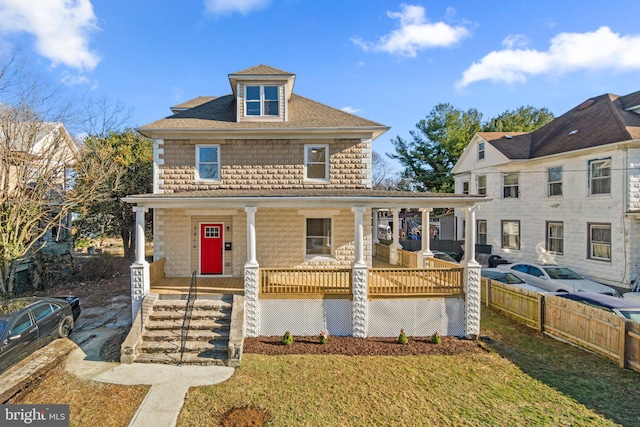 view of front facade featuring a front yard and a porch