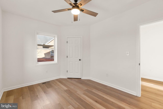 empty room featuring ceiling fan and light hardwood / wood-style flooring