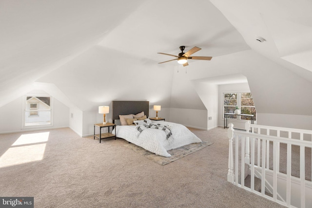 carpeted bedroom with ceiling fan and vaulted ceiling