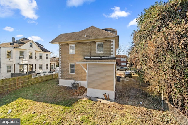 rear view of property with a yard