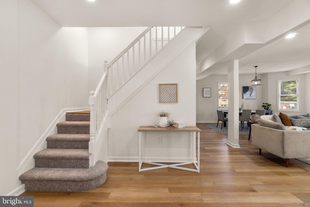 stairway featuring a chandelier and hardwood / wood-style flooring