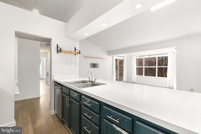 kitchen featuring dishwasher, sink, dark hardwood / wood-style flooring, pendant lighting, and lofted ceiling