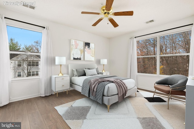 bedroom with ceiling fan and hardwood / wood-style floors