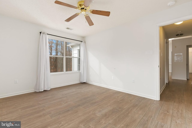 spare room featuring light hardwood / wood-style floors and ceiling fan