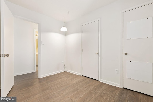 unfurnished room with hardwood / wood-style floors