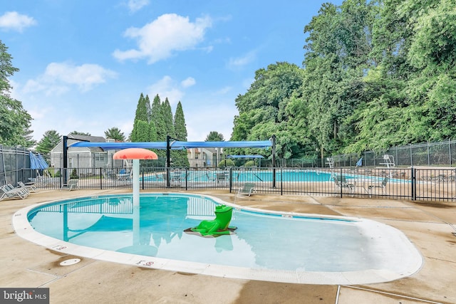 view of swimming pool with a patio area