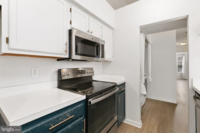 kitchen featuring light hardwood / wood-style floors, white cabinetry, and appliances with stainless steel finishes