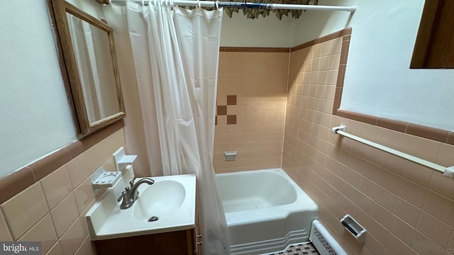 bathroom featuring vanity, shower / bathtub combination with curtain, and tile walls