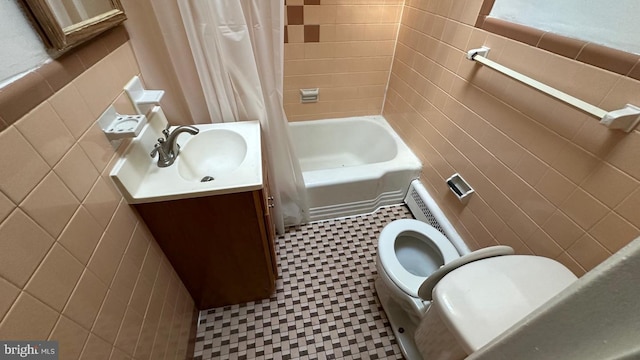 full bathroom with vanity, shower / bathtub combination with curtain, tile walls, and toilet