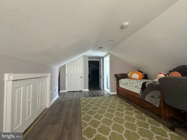 bedroom featuring lofted ceiling and dark wood-type flooring