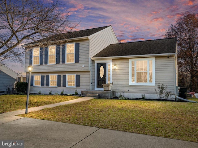 tri-level home featuring a lawn