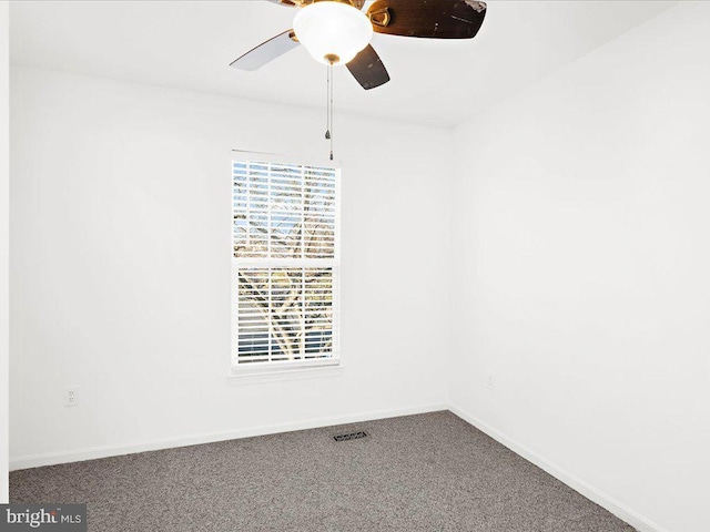 unfurnished room with ceiling fan and carpet