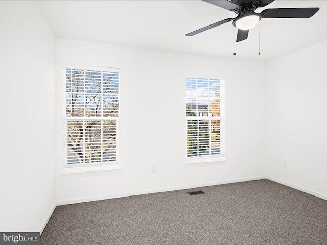 empty room featuring ceiling fan and carpet floors