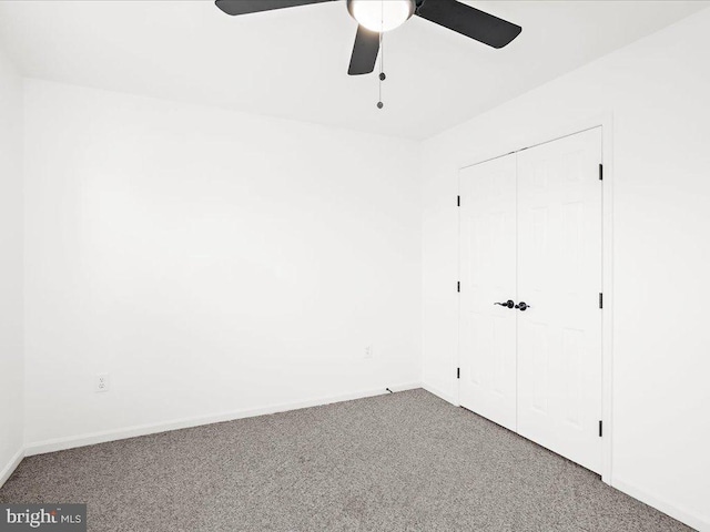 unfurnished bedroom featuring ceiling fan, a closet, and carpet floors