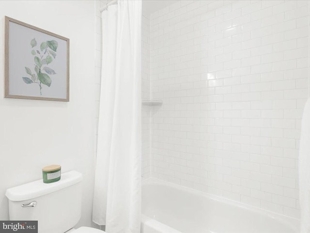 bathroom with shower / bath combo with shower curtain and toilet