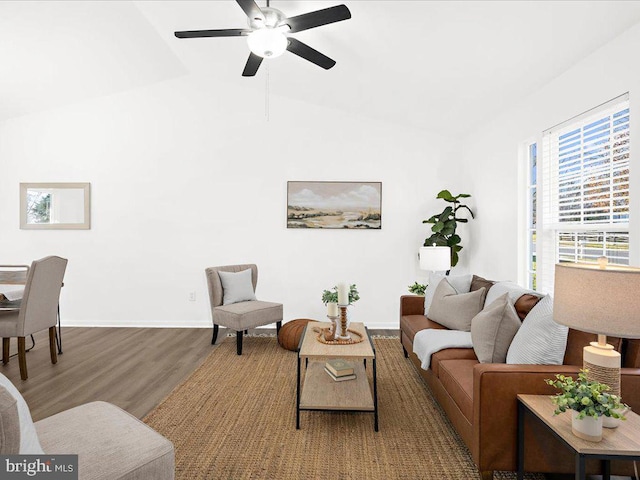 living room featuring ceiling fan, vaulted ceiling, and hardwood / wood-style flooring