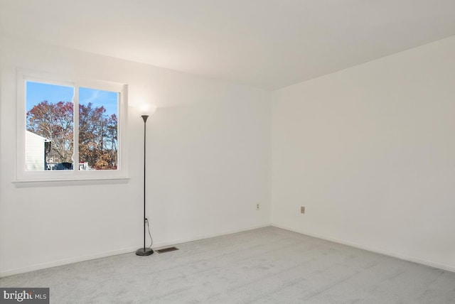 unfurnished room featuring light carpet