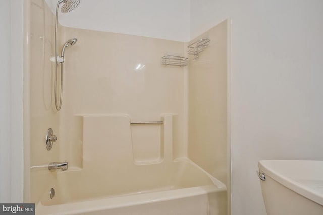 bathroom featuring shower / bathing tub combination and toilet