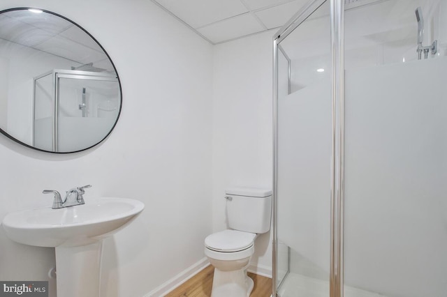 bathroom with hardwood / wood-style flooring, toilet, and walk in shower