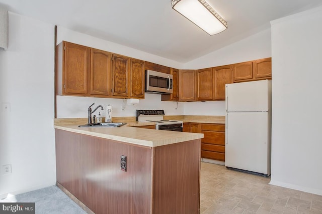 kitchen featuring kitchen peninsula, white appliances, lofted ceiling, and sink