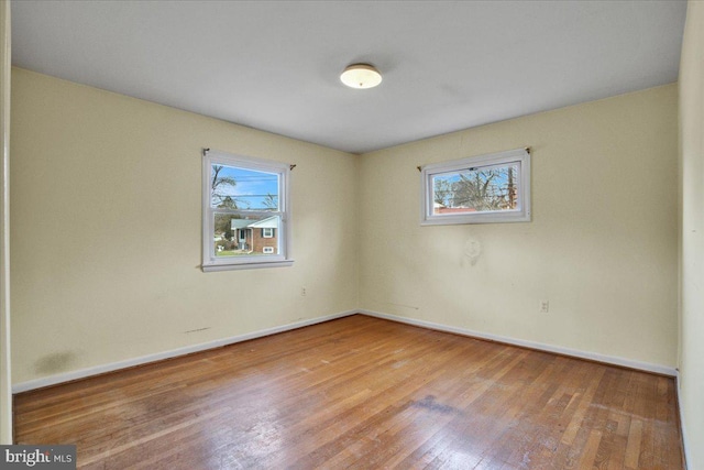 unfurnished room with light wood-type flooring and plenty of natural light