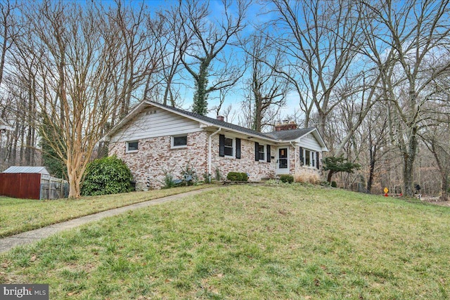 single story home with a shed and a front lawn