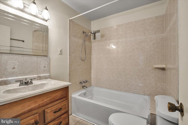 full bathroom with tile patterned floors, vanity, toilet, and tiled shower / bath