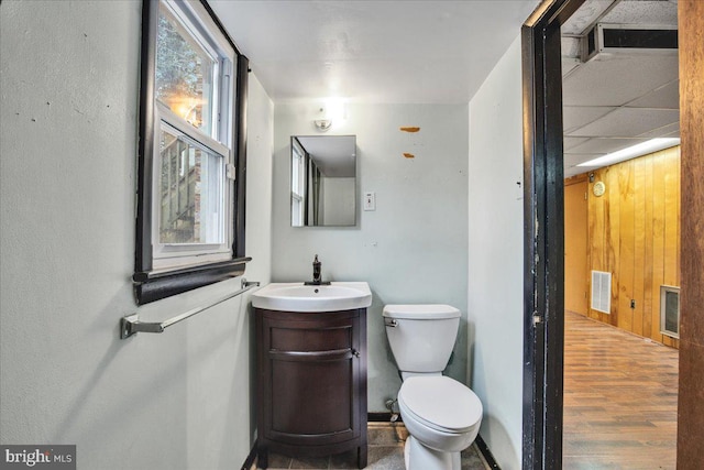 bathroom featuring vanity, hardwood / wood-style flooring, and toilet