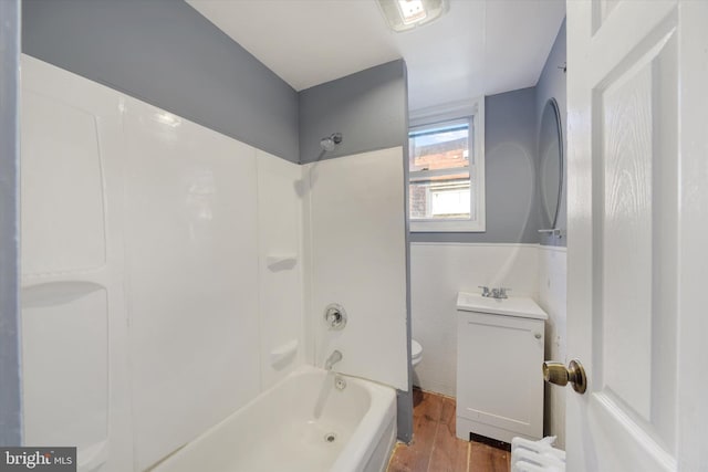 full bathroom featuring radiator, shower / bath combination, toilet, tile walls, and hardwood / wood-style flooring