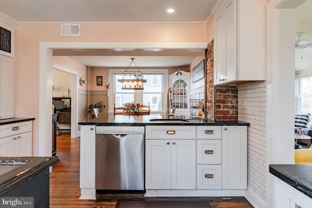 kitchen featuring dishwasher, sink, dark wood-type flooring, pendant lighting, and white cabinets