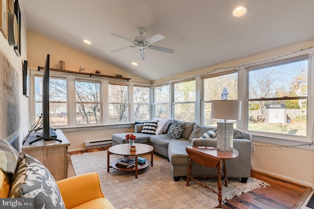 sunroom featuring ceiling fan, a baseboard radiator, and vaulted ceiling