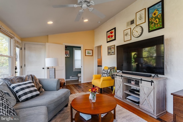 living room featuring hardwood / wood-style floors, ceiling fan, and lofted ceiling