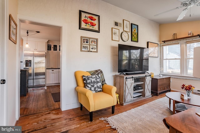 living room with vaulted ceiling, light hardwood / wood-style flooring, and ceiling fan