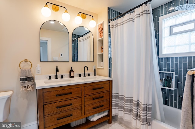 full bathroom with shower / tub combo with curtain, vanity, and toilet