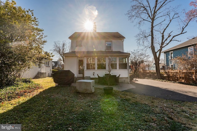 back of property featuring a yard