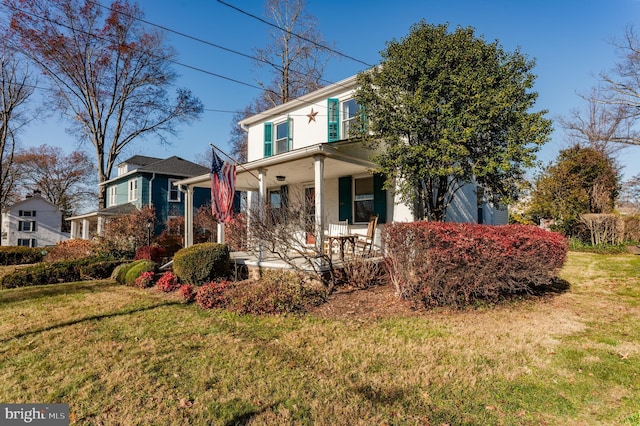 view of front of house featuring a front lawn and covered porch