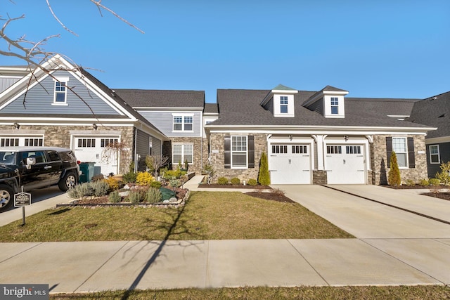 view of front of property with a garage and a front lawn