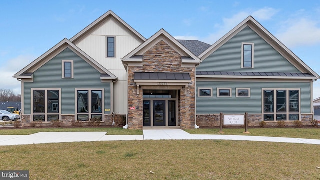 view of front of house featuring a front yard and french doors